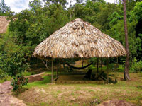 Palapa overlooking the river with two shaded hammocks