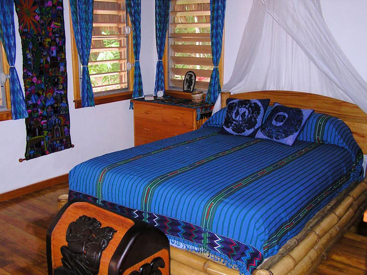 Bedroom furnished with queen sized bamboo bed and mayan weavings